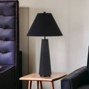 Elegant black ceramic table lamp providing soft ambient lighting in living room